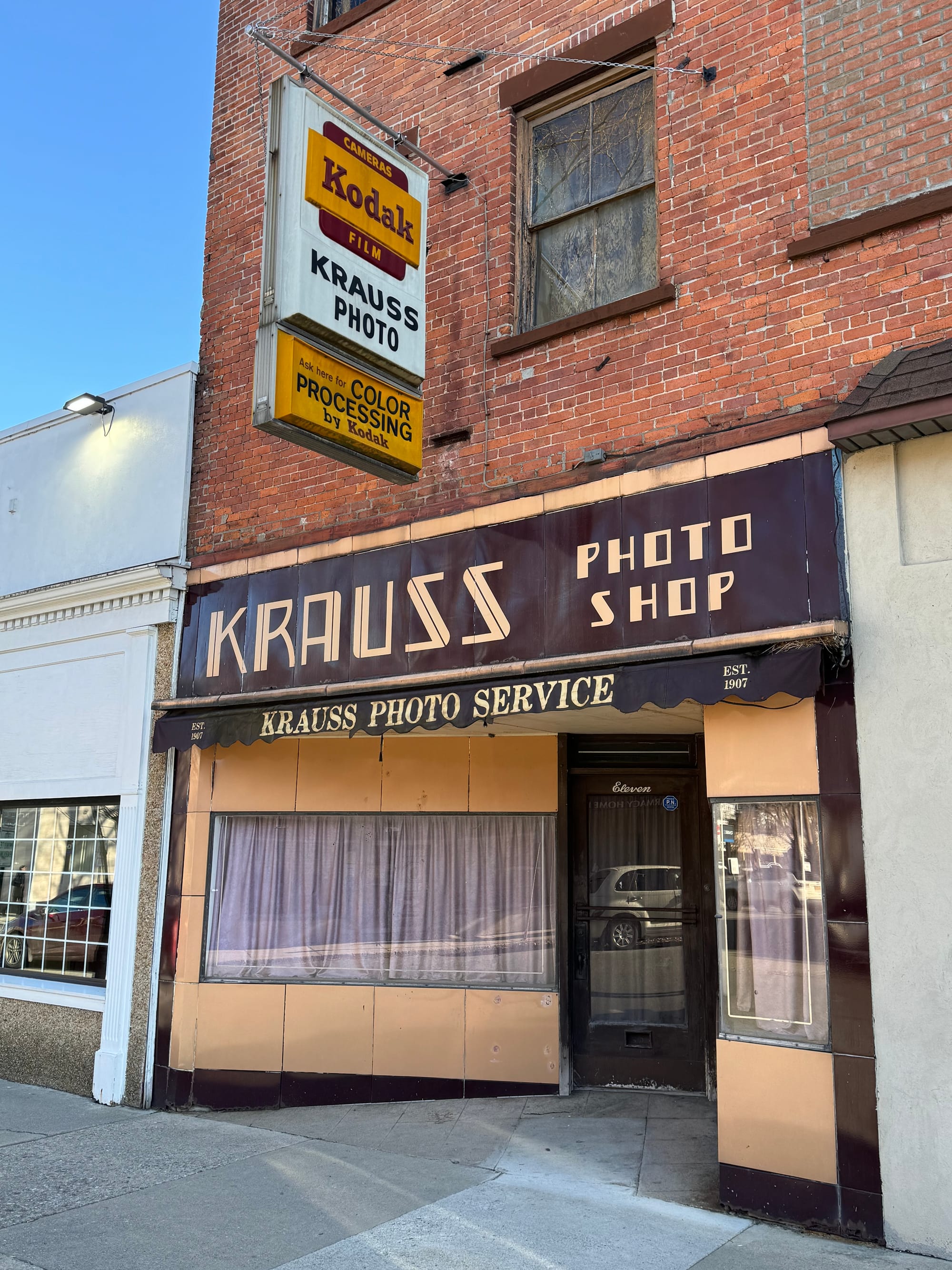 An unchanged storefront from the 1960s for Krauss Photo Service, with an old KODAK sign still hanging out front in Port Jervis, NY. 